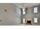 Spacious living room has tall ceilings, bright windows, red brick fireplace, and a ceiling fan at 90 Ashford Dr, Oxford, GA 30054