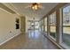 Bright sunroom featuring tile flooring, ceiling fans, and multiple windows with outdoor view at 90 Ashford Dr, Oxford, GA 30054