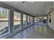 Bright sunroom with tile flooring, white trim, and multiple windows showcasing backyard at 90 Ashford Dr, Oxford, GA 30054