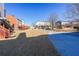 A view of backyard space behind homes, with stairs to upper stories and a private parking area at the back at 1294 Park Pass Way, Suwanee, GA 30024