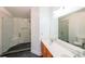 Bathroom featuring double sinks, walk-in shower with glass doors and stylish fixtures at 1294 Park Pass Way, Suwanee, GA 30024