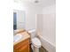 A bathroom featuring a clean white tub, toilet, vanity with sink and neutral tile floor at 1294 Park Pass Way, Suwanee, GA 30024