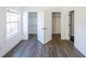 Bedroom with hardwood floors, natural light from the window and two closet entrances at 1294 Park Pass Way, Suwanee, GA 30024
