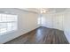 Large bedroom with tray ceilings, ceiling fan, and ample natural light from multiple windows at 1294 Park Pass Way, Suwanee, GA 30024