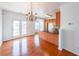 Kitchen and dining area featuring wood floors, white walls, wood cabinets, and French doors to the outside at 1294 Park Pass Way, Suwanee, GA 30024
