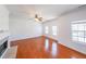 Spacious living room featuring hardwood floors, fireplace, and multiple windows for natural light at 1294 Park Pass Way, Suwanee, GA 30024