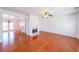 Open-concept living room with hardwood floors, fireplace, and easy access to dining area at 1294 Park Pass Way, Suwanee, GA 30024