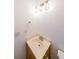 Compact powder room with sink, storage, decorative lighting, and neutral decor at 1294 Park Pass Way, Suwanee, GA 30024