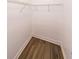 Walk-in closet showing neutral-toned hardwood floors, white trim, and a wire shelving unit at 1294 Park Pass Way, Suwanee, GA 30024