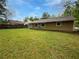 Spacious backyard with green lawn and the exterior of a cozy home at 245 Adena W Ln, Atlanta, GA 30349