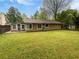 Spacious backyard featuring a well-maintained lawn, a chain-link fence, and mature trees at 245 Adena W Ln, Atlanta, GA 30349