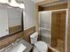 Bathroom featuring tiled walls, a glass-enclosed shower, and sleek fixtures at 245 Adena W Ln, Atlanta, GA 30349