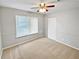 Well-lit bedroom featuring neutral carpet, a window with blinds, and a standard closet door at 245 Adena W Ln, Atlanta, GA 30349