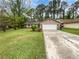 Charming single-story home featuring a stone facade, a two-car garage, and a well-maintained front yard at 245 Adena W Ln, Atlanta, GA 30349