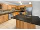 Well-lit kitchen featuring ample cabinetry, stainless steel appliances, a tile backsplash and large island at 245 Adena W Ln, Atlanta, GA 30349