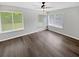 Spacious, light-filled living room with hardwood floors and large windows offering verdant views at 245 Adena W Ln, Atlanta, GA 30349
