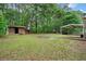 A spacious backyard features a storage shed, covered patio, and a large grassy area at 3452 Ridgecrest Dr, Powder Springs, GA 30127