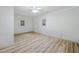 Spacious bedroom with hardwood floors, ceiling fan, and ample natural light from two windows at 3452 Ridgecrest Dr, Powder Springs, GA 30127