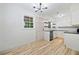 Bright kitchen featuring white cabinets, modern black countertops, and wood plank flooring at 3452 Ridgecrest Dr, Powder Springs, GA 30127