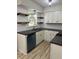 Stylish kitchen features white cabinets, floating shelves, modern appliances and sleek countertops at 3452 Ridgecrest Dr, Powder Springs, GA 30127