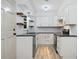 Modern kitchen with white cabinets, black countertops, and stainless steel appliances at 3452 Ridgecrest Dr, Powder Springs, GA 30127