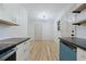 Bright kitchen showcases sleek countertops, white cabinets, open space and modern lighting at 3452 Ridgecrest Dr, Powder Springs, GA 30127