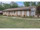 Cozy brick home boasts a well-kept lawn and an attached two-car garage at 6436 Alpine Rd, Rex, GA 30273