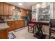 Well-lit kitchen features wooden cabinets, granite countertops, tile backsplash, and breakfast bar at 6436 Alpine Rd, Rex, GA 30273