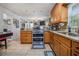 Spacious kitchen features stainless steel appliances, tiled floors, and wood cabinetry at 6436 Alpine Rd, Rex, GA 30273