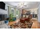 Cozy living room with fireplace, hardwood floors, and view to kitchen; perfect for entertaining at 6436 Alpine Rd, Rex, GA 30273