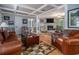 Comfortable living room featuring a brick fireplace and hardwood floors at 6436 Alpine Rd, Rex, GA 30273