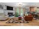 Cozy living room with brick fireplace and wooden floors at 6436 Alpine Rd, Rex, GA 30273
