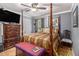 Comfortable main bedroom with hardwood floors, neutral colors, and traditional decor at 6436 Alpine Rd, Rex, GA 30273