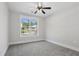 Neutral bedroom featuring a ceiling fan, carpet, and view of yard at 1002 Coleman Sw St, Atlanta, GA 30310