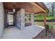Inviting covered front porch featuring stone pillars, wood beam accents, and stylish pendant lighting at 1002 Coleman Sw St, Atlanta, GA 30310