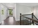Upstairs hallway with access to balcony, hardwood flooring and neutral paint at 1002 Coleman Sw St, Atlanta, GA 30310