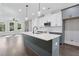 Bright, open kitchen featuring a large island with quartz countertop and modern stainless steel appliances at 1002 Coleman Sw St, Atlanta, GA 30310