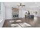 Open floorplan with hardwood floors, a stone fireplace, and a modern kitchen island at 1002 Coleman Sw St, Atlanta, GA 30310