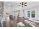 Open floorplan with hardwood floors, a stone fireplace, kitchen island, and sliding glass doors to the outside at 1002 Coleman Sw St, Atlanta, GA 30310
