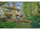 Inviting backyard with a well-maintained lawn, wood bridge and lovely patio area for outdoor relaxation at 2008 Falcon Glen Ct, Alpharetta, GA 30022