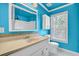 Bathroom features blue walls, white cabinetry, and a decorative mirror at 2008 Falcon Glen Ct, Alpharetta, GA 30022