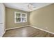 Relaxing bedroom featuring wood-look flooring, neutral paint, ceiling fan, and bright window view at 2008 Falcon Glen Ct, Alpharetta, GA 30022