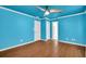 Bedroom with hardwood floor and blue walls with a view into the hallway at 2008 Falcon Glen Ct, Alpharetta, GA 30022