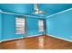 Bedroom features hardwood flooring, blue walls, ceiling fan, and window with curtains at 2008 Falcon Glen Ct, Alpharetta, GA 30022