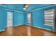 Bedroom with hardwood floor and blue walls with a view into the adjacent bathroom at 2008 Falcon Glen Ct, Alpharetta, GA 30022