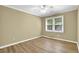 Inviting bedroom featuring wood-look flooring, neutral paint, ceiling fan, and bright natural light at 2008 Falcon Glen Ct, Alpharetta, GA 30022