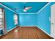 Bedroom featuring blue walls and hardwood flooring with white trim at 2008 Falcon Glen Ct, Alpharetta, GA 30022