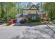 Charming yellow two-story home with well-maintained landscaping, mature trees, and an attached garage at 2008 Falcon Glen Ct, Alpharetta, GA 30022