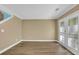 Bright living space features hardwood floors and sliding glass doors that open to an outdoor patio at 2008 Falcon Glen Ct, Alpharetta, GA 30022