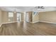 Open living area with hardwood floors, stairs, and ample natural light from a large window at 2008 Falcon Glen Ct, Alpharetta, GA 30022